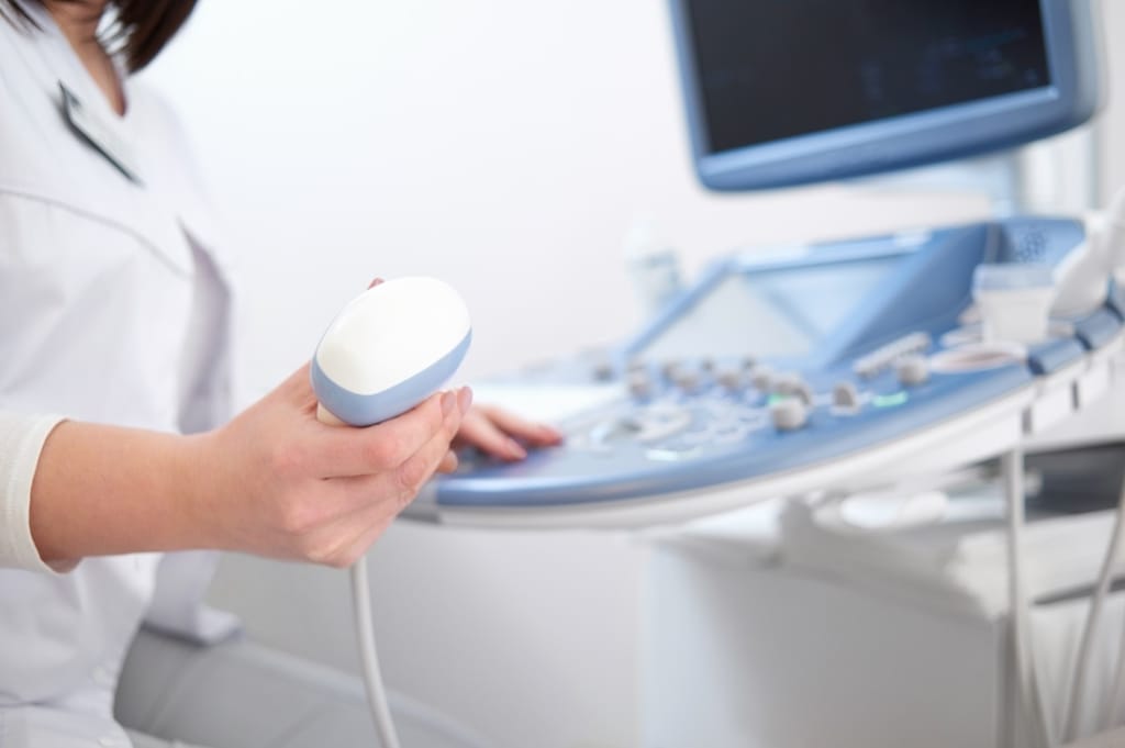 A sonographer performing an ultrasound examination
