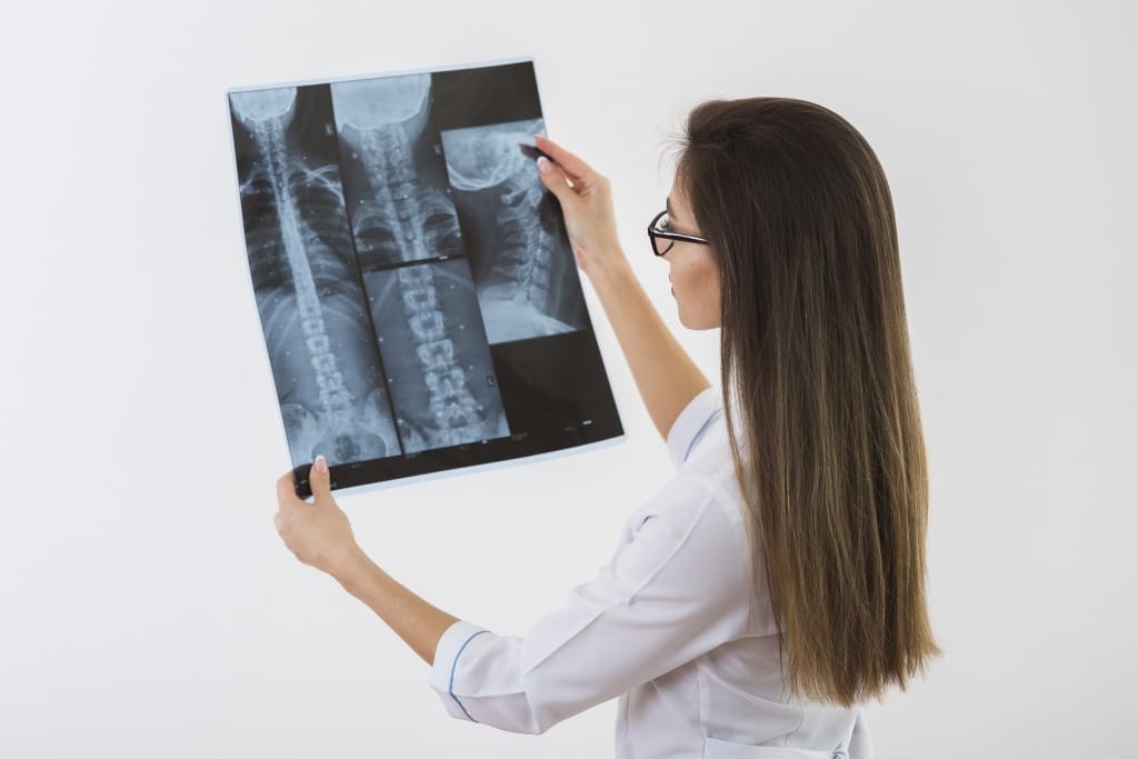 A radiographer reviewing an X-ray image